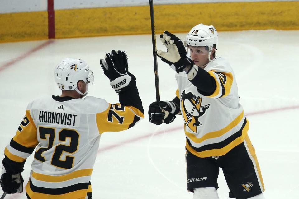 Pittsburgh Penguins center Jared McCann (19) celebrates his goal against the Arizona Coyotes with Penguins right wing Patric Hornqvist (72) during the first period of an NHL hockey game Sunday, Jan. 12, 2020, in Glendale, Ariz. (AP Photo/Ross D. Franklin)