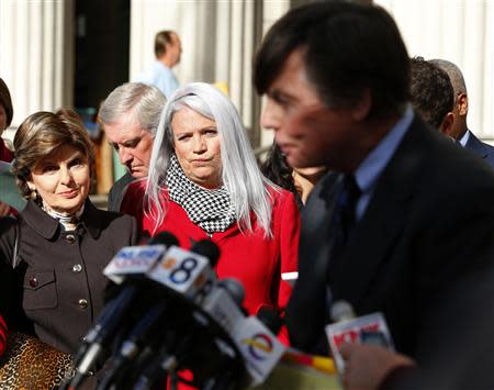 Irene McCormack Jackson (C) and her attorney Gloria Allred (L) listen to former San Diego Mayor Bob Filner's attorney Jerry Coughlan after Filner's sentencing hearing in San Diego, California December 9, 2013. REUTERS/Mike Blake