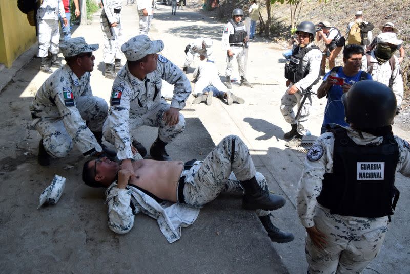 Members of Mexico's National Guard are seen injured after clashes with migrants, part of a caravan travelling to the U.S., near the border between Guatemala and Mexico