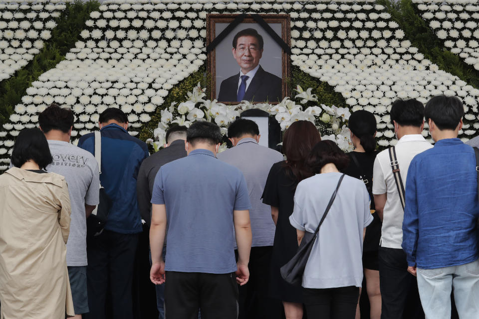 Mourners pay their respects at a memorial for late Seoul Mayor Park Won-soon at the City Hall Plaza in Seoul, South Korea, Sunday, July 12, 2020. The sudden death of Seoul's mayor, reportedly implicated in a sexual harassment complaint, has prompted an outpouring of public sympathy even as it has raised questions about a man who built his career as a reform-minded politician and self-described feminist. (AP Photo/Ahn Young-joon)