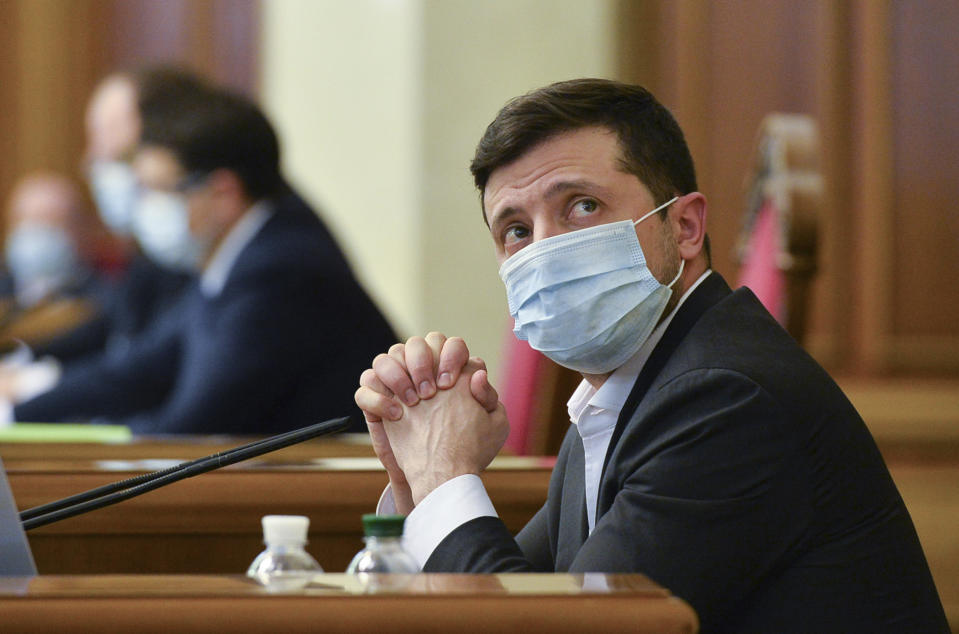 FILE - In this file photo dated Tuesday, March 31, 2020, Ukrainian President Volodymyr Zelenskiy wears a face mask to protect against coronavirus during an extraordinary parliamentary session in Kyiv, Ukraine. It is announced Monday Nov. 9, 2020, that Volodymyr Zelenskiy has tested positive for the COVID-19 coronavirus. (AP Photo, FILE)