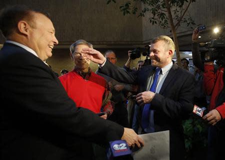 Utah state senator Jim Dabakis (L) is married to his partner of 27 years, Stephen Justesen (R) by Salt Lake City Mayor Ralph Becker (C) at the Salt Lake County office building in Salt Lake City, Utah, December 20, 2013. REUTERS/Jim Urquhart