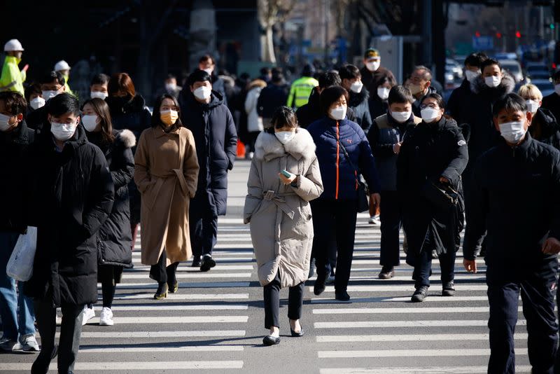 Commuters cross a zebra crossing, amid the coronavirus disease (COVID-19) pandemic in Seoul