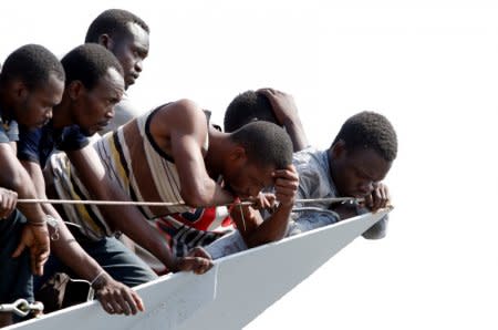 Migrants wait to disembark from the Italian Navy vessel Sfinge in the Sicilian harbour of Pozzallo, southern Italy, August 31, 2016. REUTERS/ Antonio Parrinello