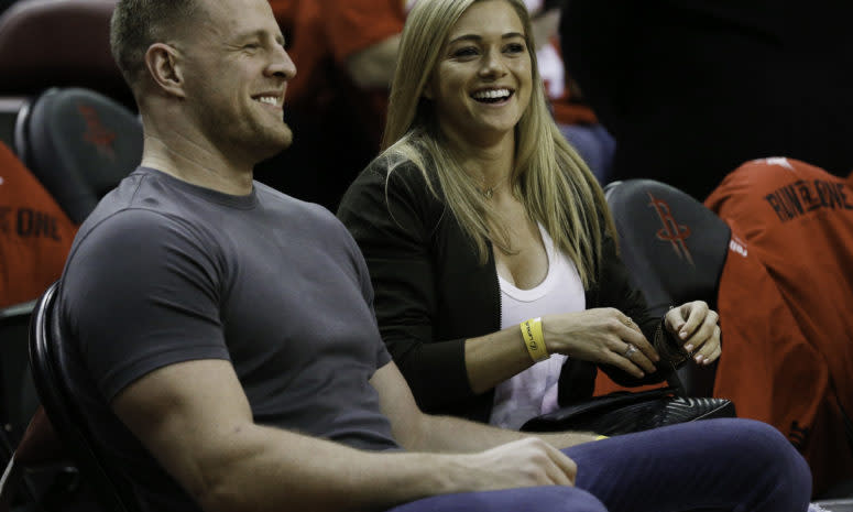 jj watt and his fiancee at a houston rockets game