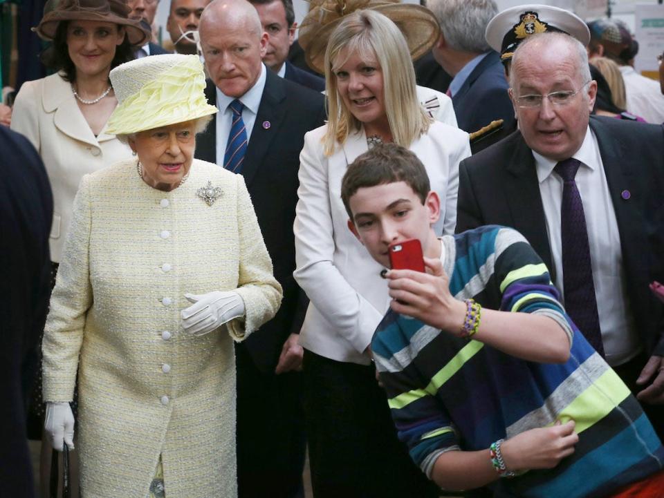 A boy grabs an impromptu selfie with Queen Elizabeth in 2014.
