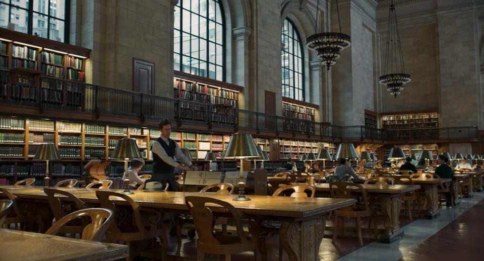 Lionel Essrog (Edward Norton) researches old newspaper clippings at the New York Public Library.