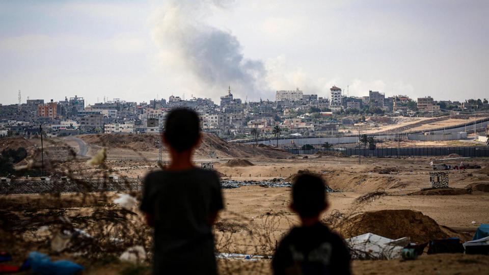 PHOTO: Boys watch smoke billowing during Israeli strikes east of Rafah in the southern Gaza Strip, May 13, 2024, amid the ongoing conflict between Israel and the Palestinian militant group Hamas. (AFP via Getty Images)