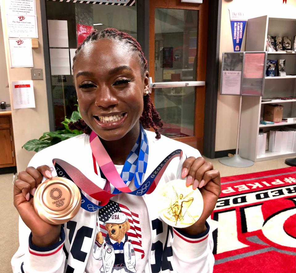 Lynna Irby displays her Olympic gold and bronze medals.