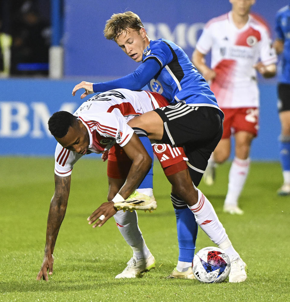 CF Montreal's Bryce Duke, right, challenges New England Revolution's Mark-Anthony Kaye during the first half of an MLS soccer match Saturday, Aug. 26, 2023, in Montreal. (Graham Hughes/The Canadian Press via AP)
