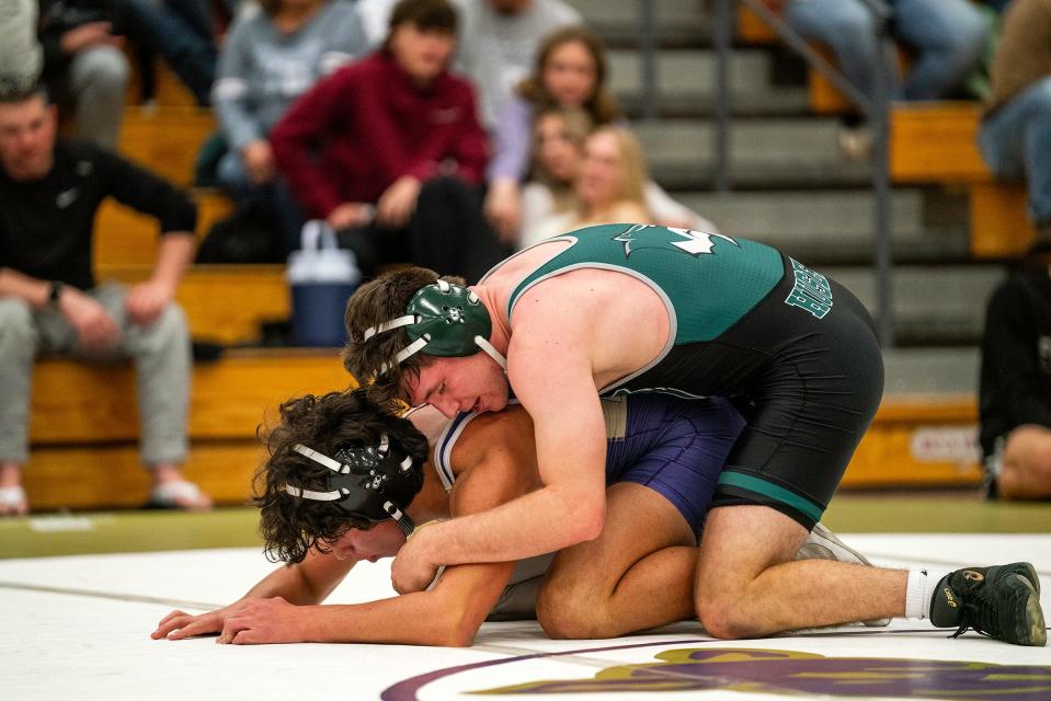 Fossil Ridge wrestler Alex Husen holds Fort Collins' Sorin Sierra down during a finals match of the Arnold Torgerson Memorial wrestling tournament in January. Husen is one of 42 local qualifiers for the state wrestling tournament.