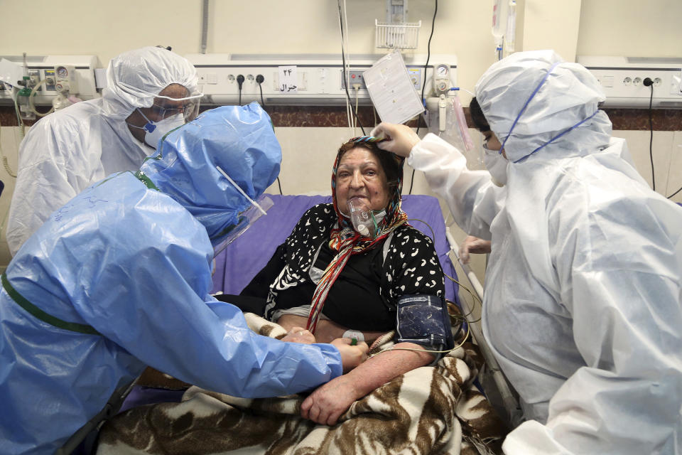 Medics treat a patient infected with the new coronavirus, at a hospital in Tehran, Iran, Sunday, March 8, 2020. With the approaching Persian New Year, known as Nowruz, officials kept up pressure on people not to travel and to stay home. Health Ministry spokesman Kianoush Jahanpour, who gave Iran's new casualty figures Sunday, reiterated that people should not even attend funerals. (AP Photo/Mohammad Ghadamali)