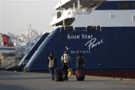 Passengers walk on a promenade during a general labour strike at Piraeus port, near Athens April 9, 2014. REUTERS/Yorgos Karahalis