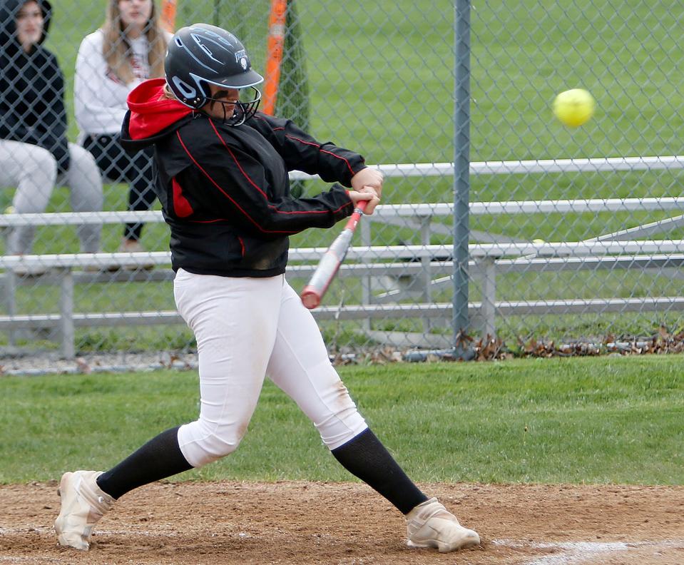 Crestview High School's PJ Endicott (22) connects with a pitch  against New London during high school softball action Tuesday, April 26, 2022 at Crestview High School. TOM E. PUSKAR/TIMES-GAZETTE.COM