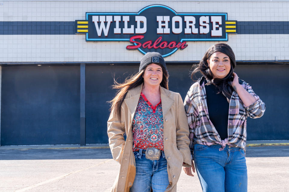 Julie Pamplin Castaneda, left, walks past Wild Horse Saloon with her daughter and general manager, Rikae Garcia, right, Saturday morning.