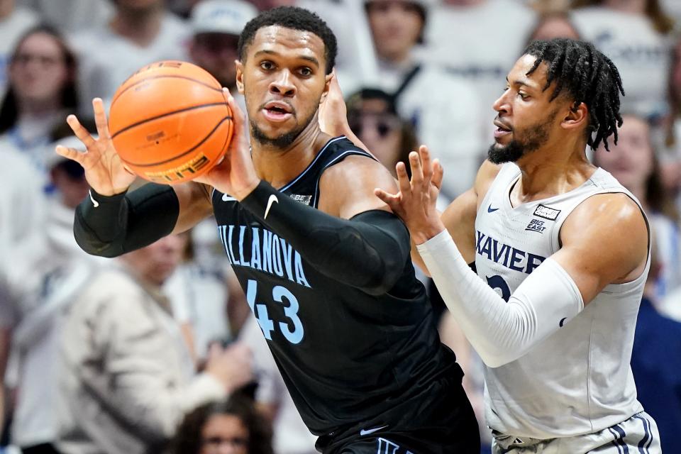 Villanova Wildcats forward Eric Dixon (43) passes as Xavier Musketeers forward Jerome Hunter (2) defends in the second half of a college basketball game between the Villanova Wildcats and the Xavier Musketeers, Tuesday, Feb. 21, 2023, at Cintas Center in Cincinnati. The Villanova Wildcats won, 64-63. 