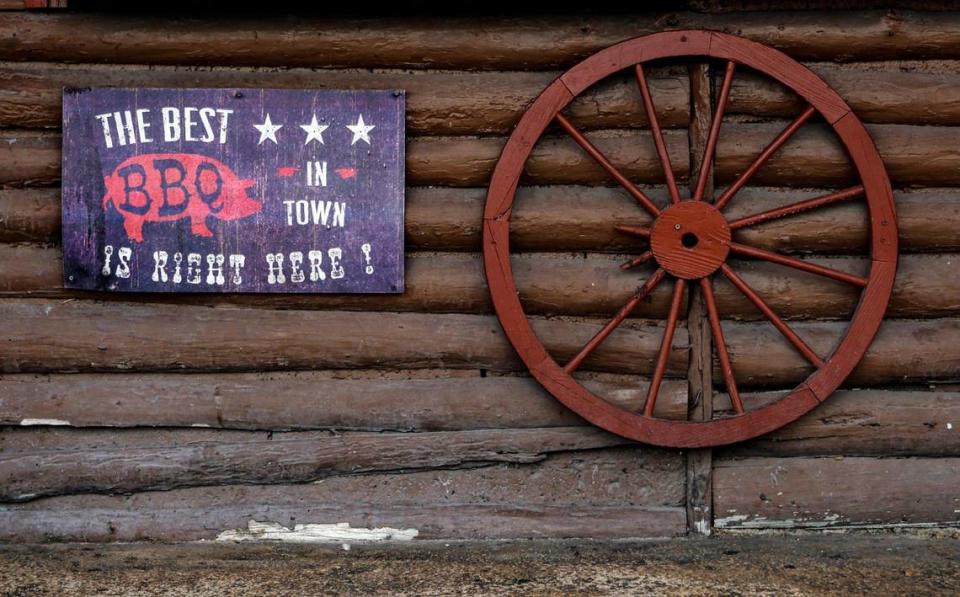 A sign and wagon wheel on the front facade of Shivers Bar-B-Q in Homestead.