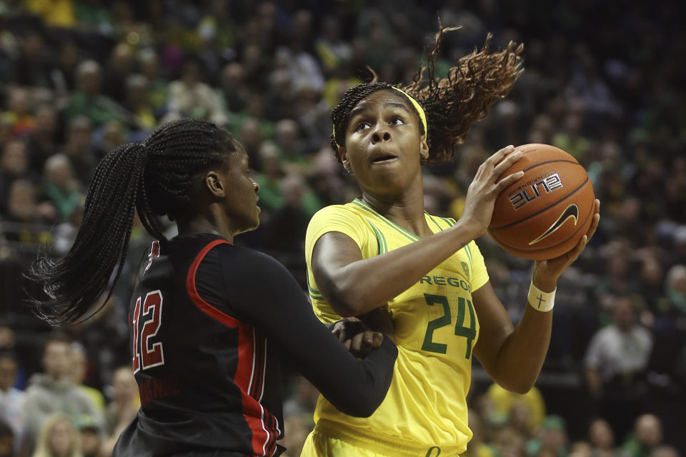 Oregon's Ruthy Hebard, right, maneuvers for position under the basket against Utah's Lola Pendande during the third quarter of an NCAA college basketball game in Eugene, Ore., Sunday, Jan. 5, 2020. (AP Photo/Chris Pietsch)