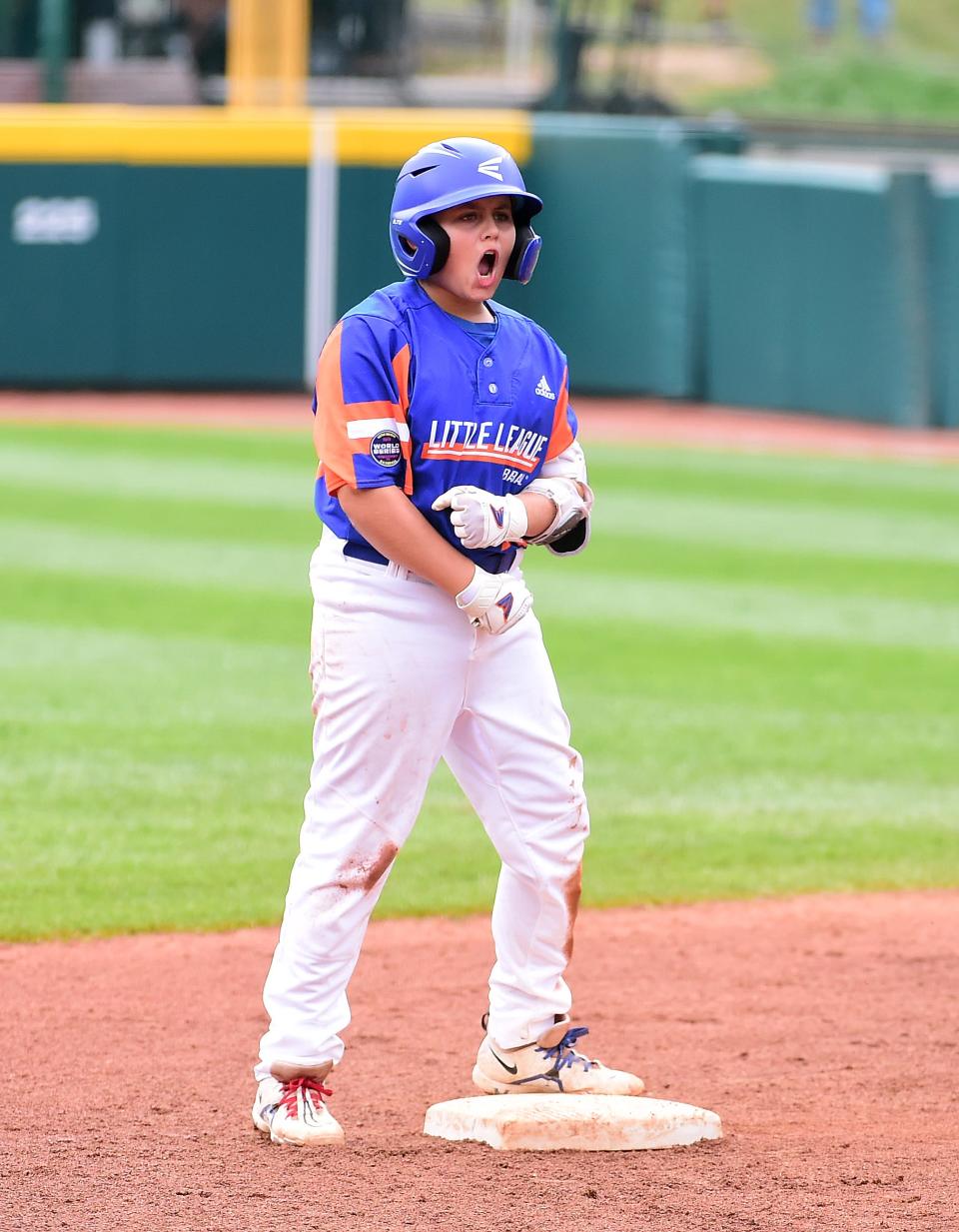 Aug 29, 2021; Williamsport, PA, USA; Great Lakes Region (Michigan) third baseman Jackson Surma (22) reacts after hitting a two run double in the first inning against Great Lakes Region (Ohio) during the Little League World Series Championship game at Howard J. Lamade Stadium. Mandatory Credit: Evan Habeeb-USA TODAY Sports