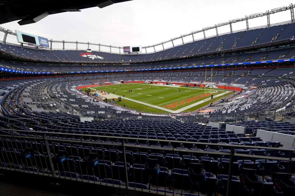 Empower Field sits without fans as the Denver Broncos warm up before facing the Buffalo Bills in an NFL football game Saturday, Dec. 19, 2020, in Denver. (AP Photo/David Zalubowski)