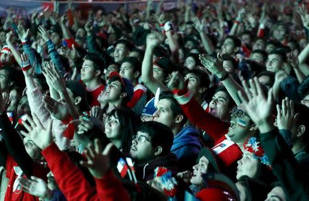 Chilean soccer fans watch the Copa America 2015 final soccer match between Chile and Argentina at a fan fest in Santiago, Chile, July 4, 2015. REUTERS/Mariana Bazo