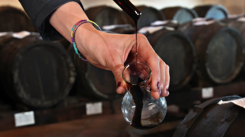 pouring balsamic vinegar into bottle