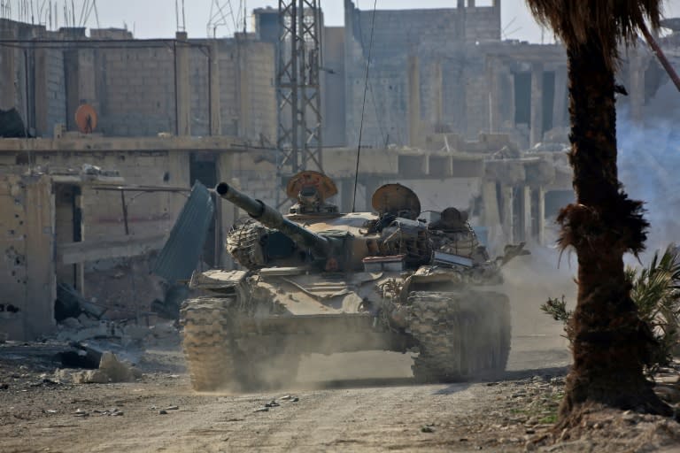 A Syrian army tank rolls into the formerly rebel-held area of Beit Nayem in Eastern Ghouta on March 6, 2018