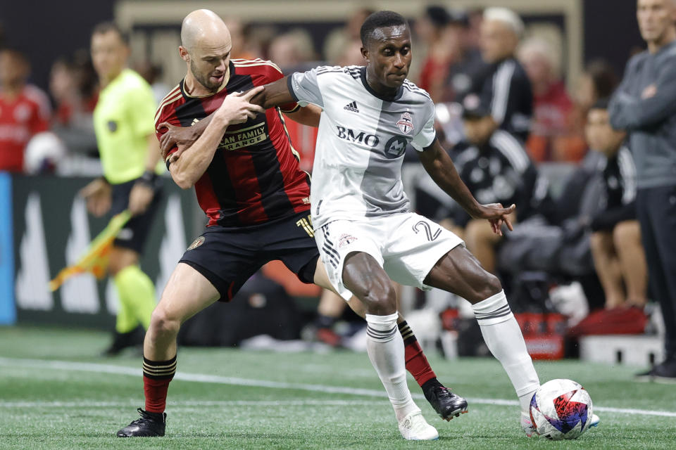 Atlanta United defender Andrew Gutman, left, and Toronto FC midfielder Richie Laryea, right, battle for the ball during the second half of an MLS soccer match, Saturday, March 4, 2023, in Atlanta. (AP Photo/Alex Slitz)