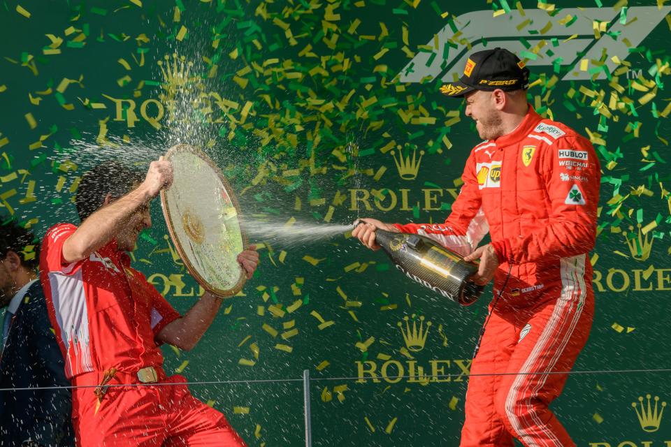 Making a splash: Sebastian Vettel celebrates on the podium after his victory at the 2018 Australian Grand Prix