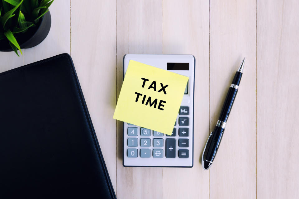 Tax Time text on adhesive note on top of calculator. Source: Getty Images