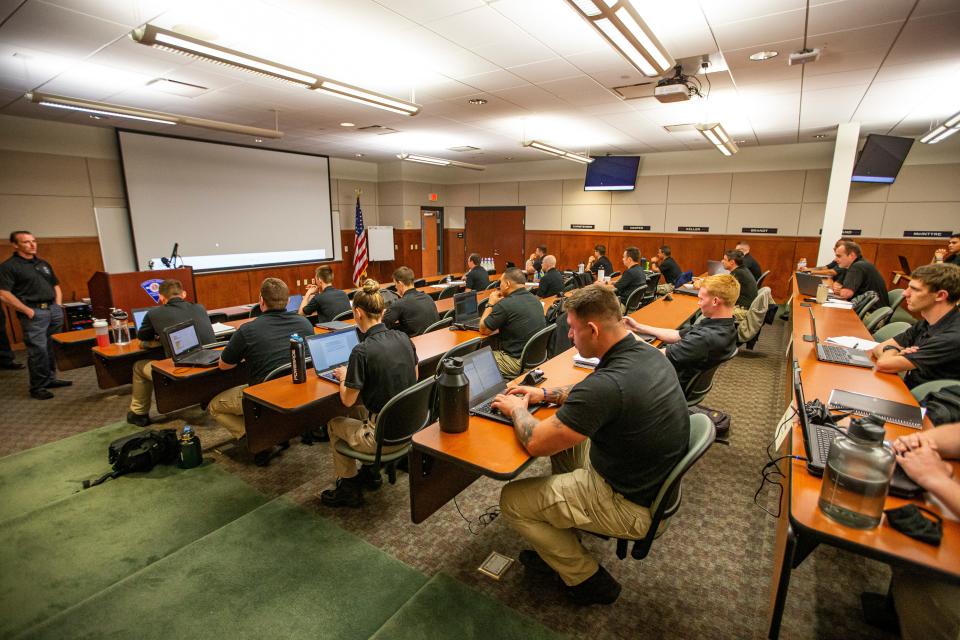 Law enforcement trainees sit in the auditorium inside the South Bend Police Department during a class last year.