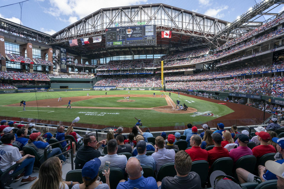 Fans fill the stands at Globe Life Field during the first inning of a baseball game between the Texas Rangers and the Toronto Blue Jays, Monday, April 5, 2021, in Arlington, Texas. The Rangers are set to have the closest thing to a full stadium in pro sports since the coronavirus shutdown more than a year ago. (AP Photo/Jeffrey McWhorter)