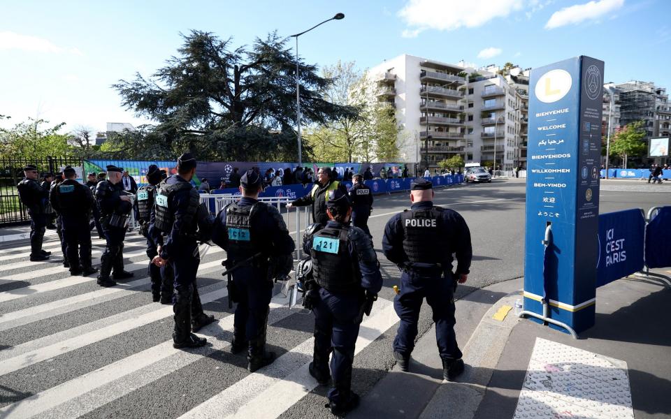 French Police officers wearing riot gears control the access to the Parc des Princes stadium