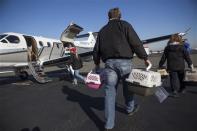 Dogs from the Front Street Animal Shelter in Sacramento, California, are loaded for a flight of 50 dogs to a no-kill shelter in Idaho, December 9, 2013. REUTERS/Max Whittaker