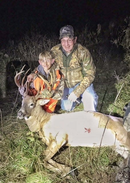 Kaden Sheat, left, and his grandfather Kevin Sheat celebrating their  successful hunt together.