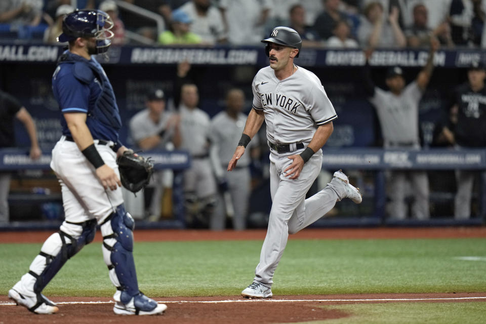 New York Yankees' Matt Carpenter, right, scores in front of Tampa Bay Rays catcher Mike Zunino on an RBI single by Aaron Judge during the sixth inning of a baseball game Thursday, May 26, 2022, in St. Petersburg, Fla. (AP Photo/Chris O'Meara)