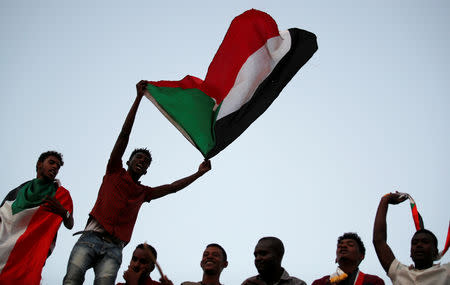 Sudanese protesters wave national flags and shout slogans as they gather for a mass protest in front of the Defence Ministry in Khartoum, Sudan, April 21, 2019. REUTERS/Umit Bektas