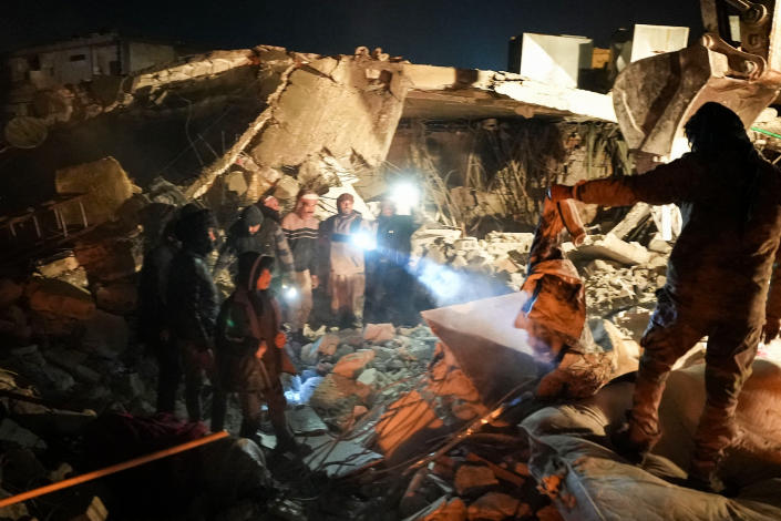 People search through the rubble of a house where a newborn baby was rescued alive on Feb. 6, 2023, in Jandaris, Syria. (Rami Al Syed / AFP - Getty Images)