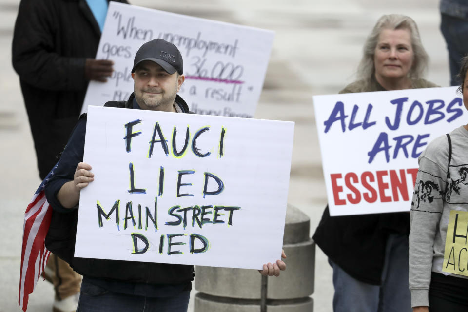 Protesters rally at the Tennessee state capitol to speak out against the state's handling of the COVID-19 outbreak Sunday, April 19, 2020, in Nashville, Tenn. Tennessee is under a stay-at-home order due to the coronavirus outbreak except for essential workers. (AP Photo/Mark Humphrey)