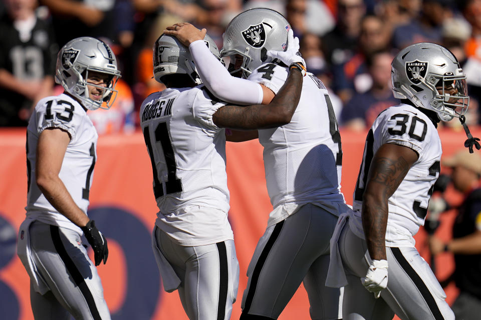 Las Vegas Raiders wide receiver Henry Ruggs III (11) celebrates his touchdown against the Denver Broncos with quarterback Derek Carr (4) during the first half of an NFL football game, Sunday, Oct. 17, 2021, in Denver. (AP Photo/Jack Dempsey)