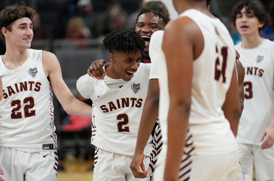 The Lutheran Saints celebrate after defeating Southwood, 97-66, for the IHSAA Class A state title Saturday, March 25, 2023, at Gainbridge Fieldhouse in Indianapolis.