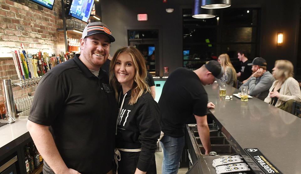 Matt and Marianne Pacha, owners of Flight Bar + Grille in Huxley, pose during the opening of their restaurant in March 2022.