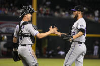 Colorado Rockies catcher Brian Serven (6) and pitcher Daniel Bard celebrate after the team's win over the Arizona Diamondbacks in a baseball game Saturday, Aug. 6, 2022, in Phoenix. (AP Photo/Rick Scuteri)