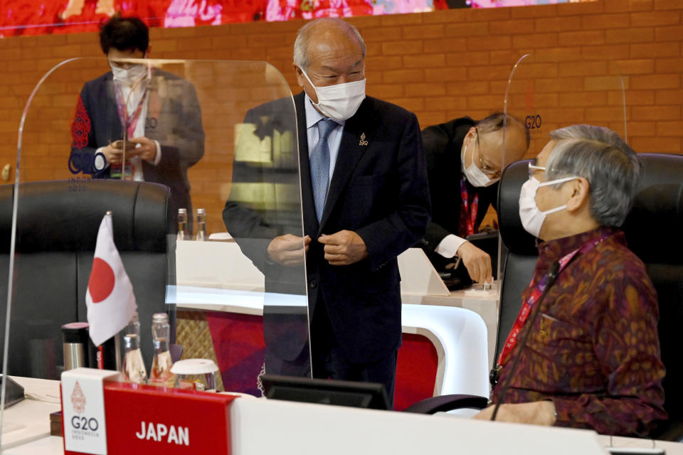 Japanese Finance Minister Shunichi Suzuki , center, talks with Japan's Central Bank Governor Haruhiko Kuroda during the second day of the G20 Finance Ministers and Central Bank Governors Meeting in Nusa Dua,Bali, Indonesia, on Saturday, July 16, 2022. (Sonny Tumbelaka/Pool Photo via AP)