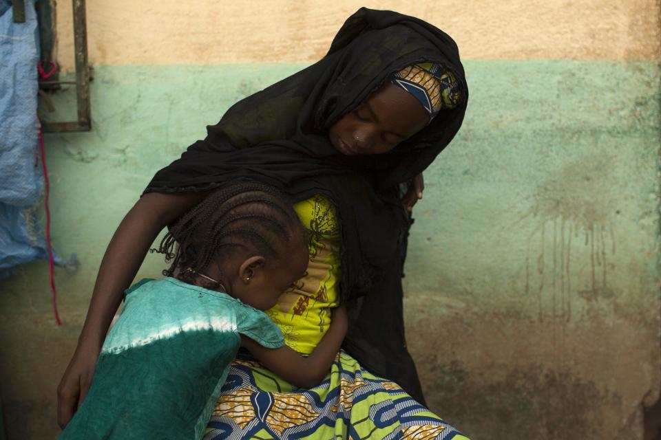 A girl embraces her mother in a madrasa, hosting internally displaced persons (IDPs) in a Muslim neighbourhood in the capital Bangui