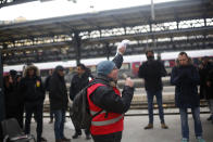 A railway worker gives a speech during a meeting at the gare de l'est Railway station, in Paris, Thursday, Dec. 12, 2019. France's prime minister said Wednesday the full retirement age will be increased for the country's youngest, but offered a series of concessions in an ill-fated effort to calm a nationwide protest against pension reforms that critics call an erosion of the country's way of life. (AP Photo/Thibault Camus)