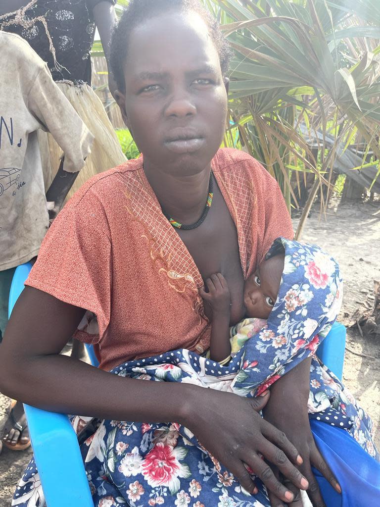 Nyabany Kong tries to feed her young son in New Fangak, Jonglei state, South Sudan. The mother told CBS News she hadn't eaten in two weeks. / Credit: CBS News