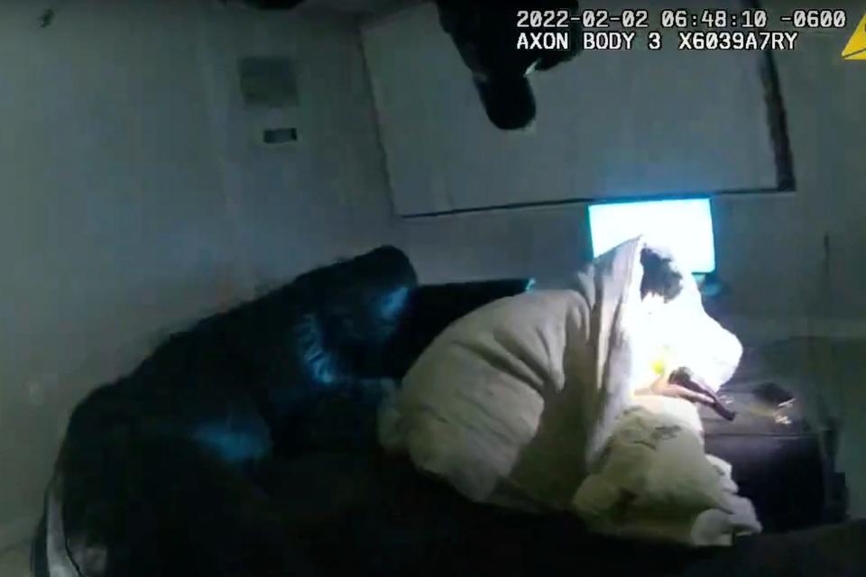 In this image taken from Minneapolis Police Department body camera video and released by the city of Minneapolis, 22-year-old Amir Locke wrapped in a blanket on a couch holding a gun moments before he was fatally shot by Minneapolis police as they were executing a search warrant in a homicide investigation on Wednesday.
