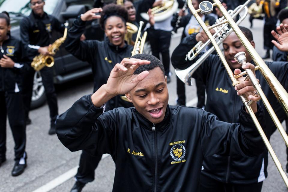 Justin Askew dances along with the Memphis Business Academy marching band before the start of the Africa in April International Diversity Parade on Friday, April 19, 2019. The 33rd annual Africa in April Cultural Awareness Festival runs through April 21 at Robert Church Park.