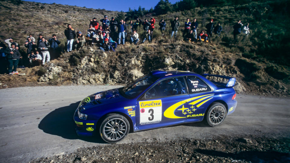 Subaru's Impreza WRC99, No. T15 SRT, racing in period.